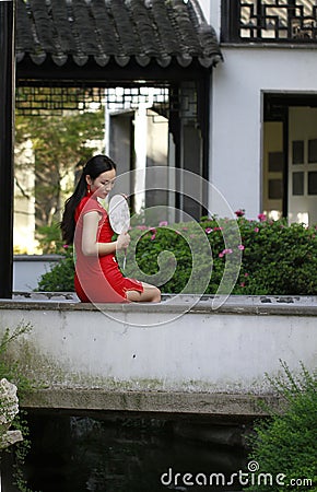 Chinese cheongsam model in Chinese classical garden Stock Photo